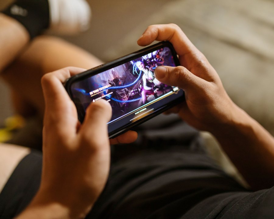 A player browsing the Royal X game library on an Android phone